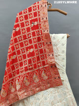 A Lehenga with white beads work and red and orange dupatta