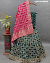 A traditional wear lehenga with Dola Silk Banarasi style embellished with white beads