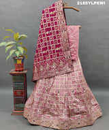A Lehenga with Banarasi style pattern and white bead work in a traditional design.