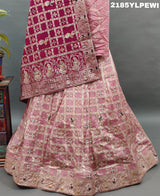 A Lehenga with Banarasi style pattern and white bead work in a traditional design.