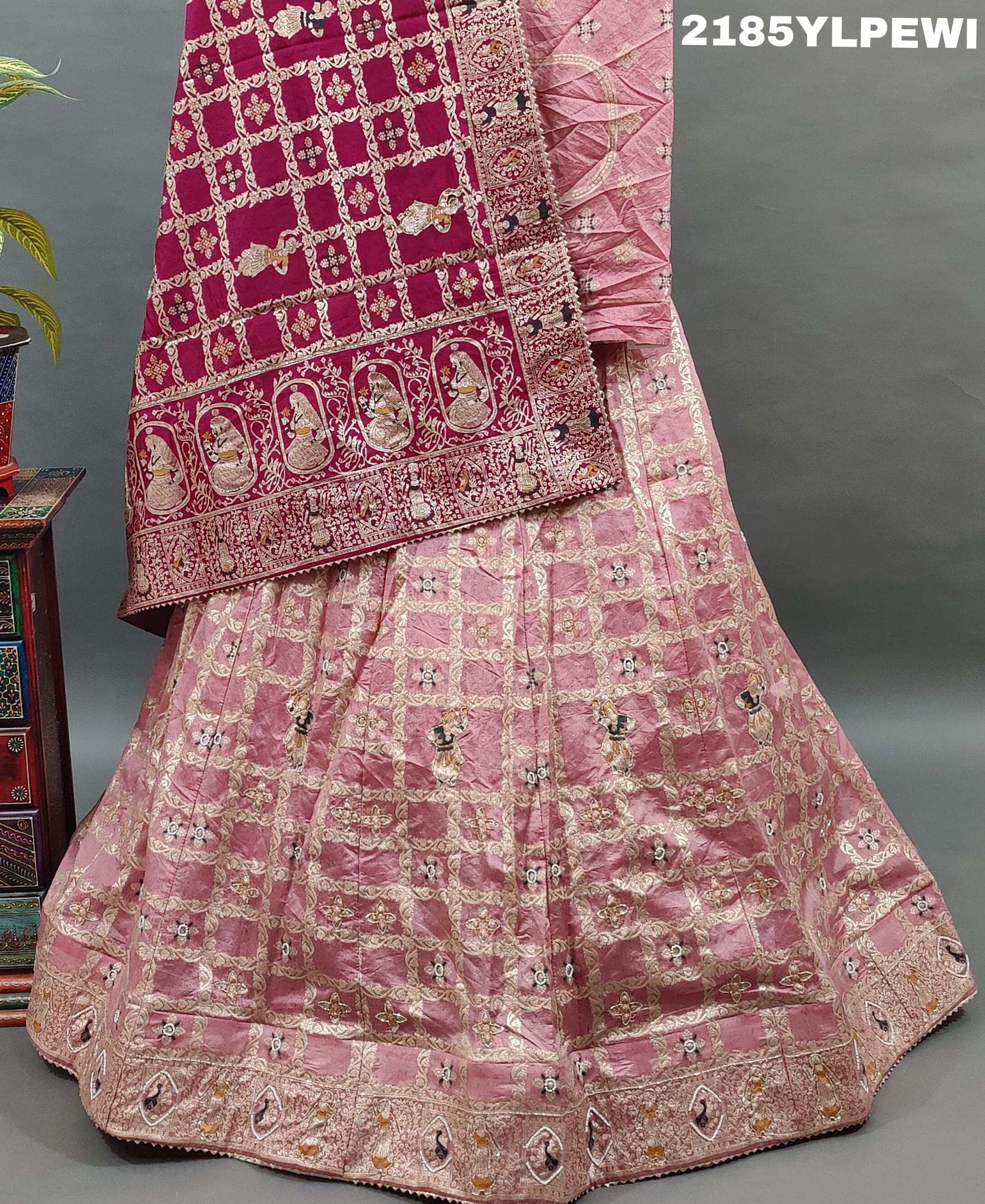 A Lehenga with Banarasi style pattern and white bead work in a traditional design.