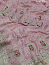 A pink tissue silk saree with traditional sequence Gotapatti work.