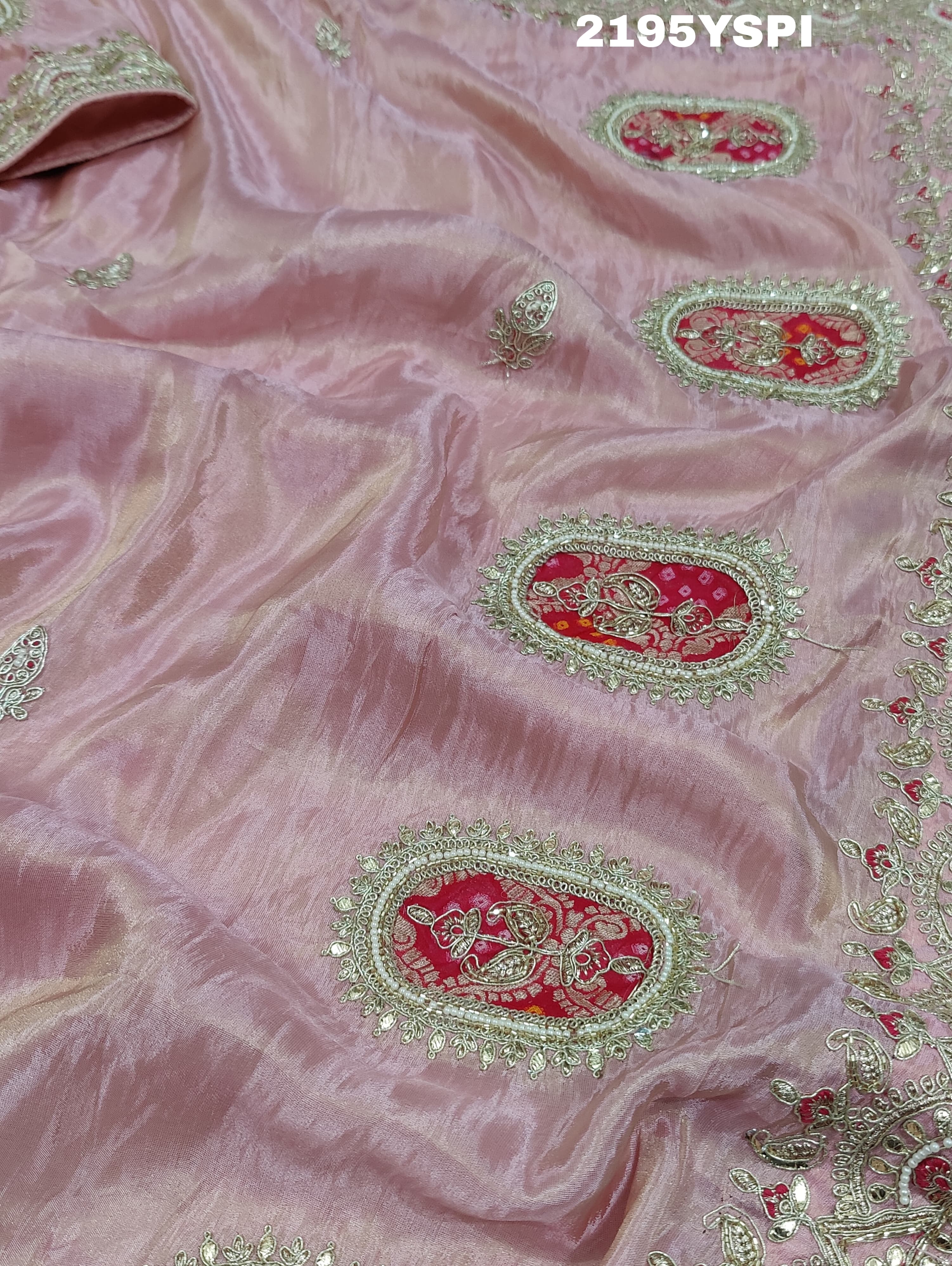A pink tissue silk saree with traditional sequence Gotapatti work.