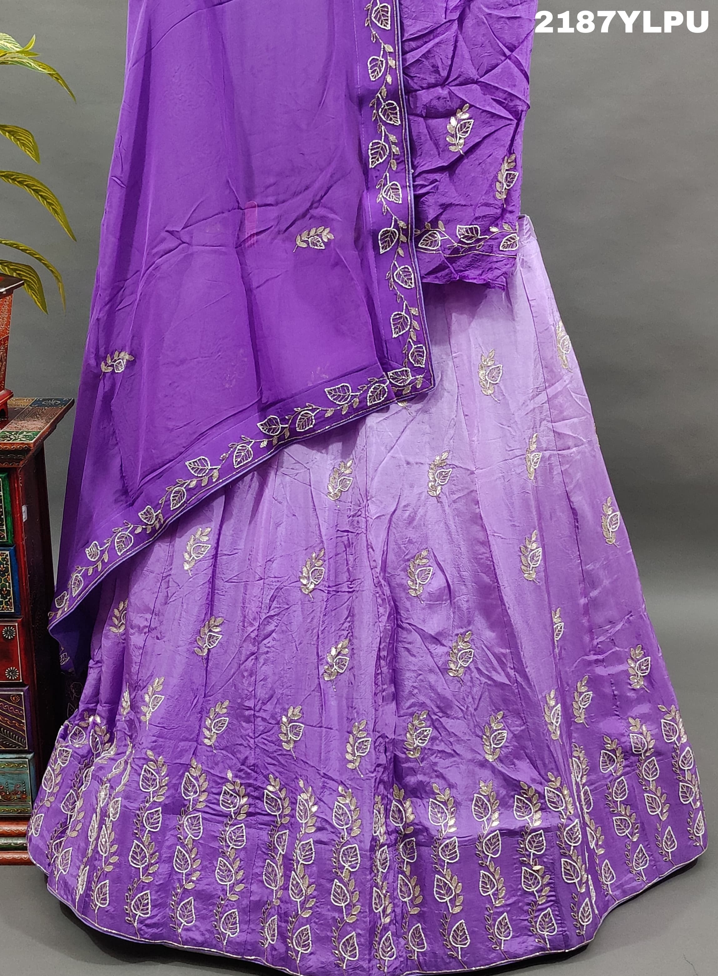A traditional style purple lehenga with white bead work