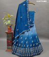 A blue traditional style silk lehenga with white bead work