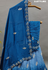 A blue traditional style silk lehenga with white bead work