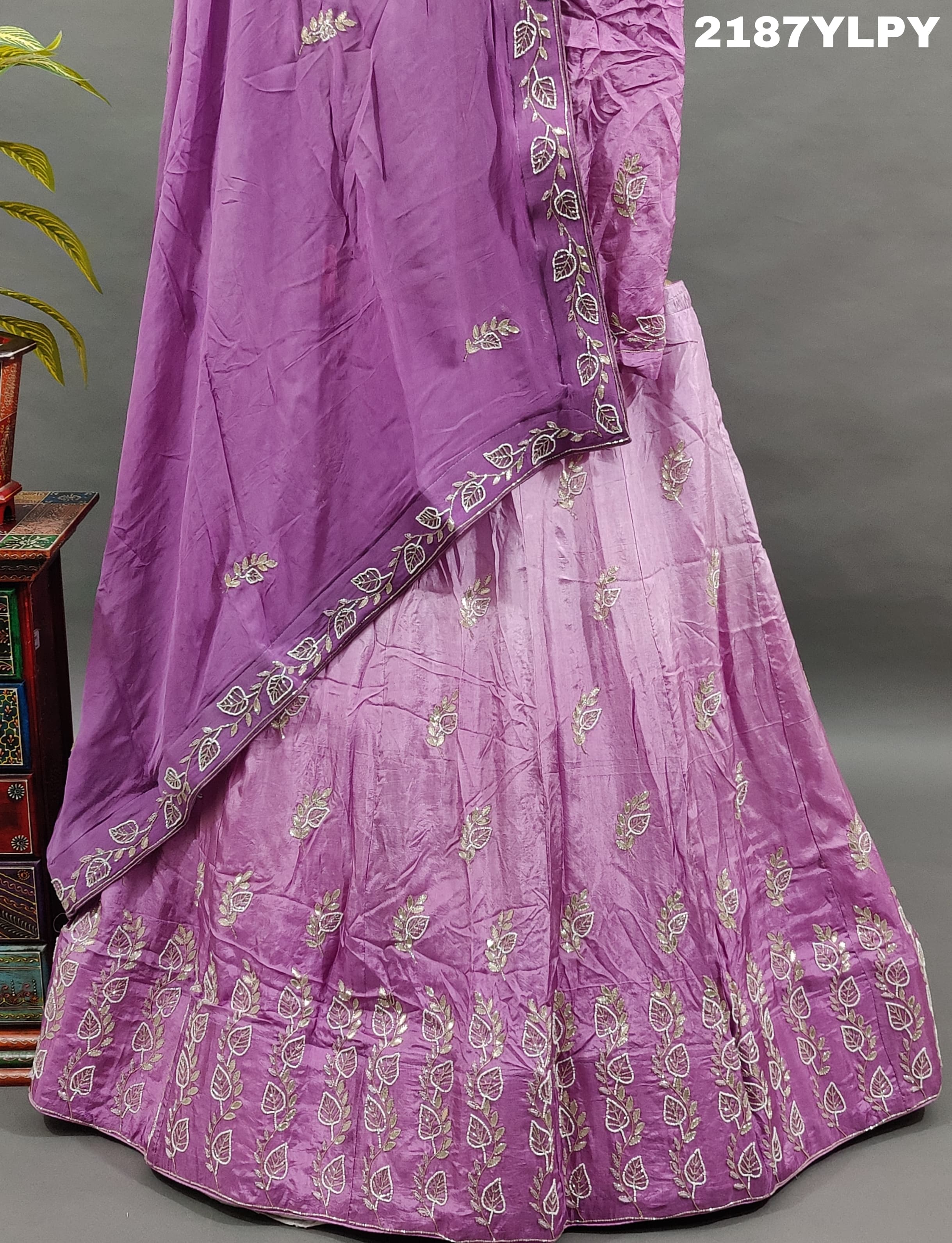 A traditional style Upada silk lehenga in purple with white bead work 