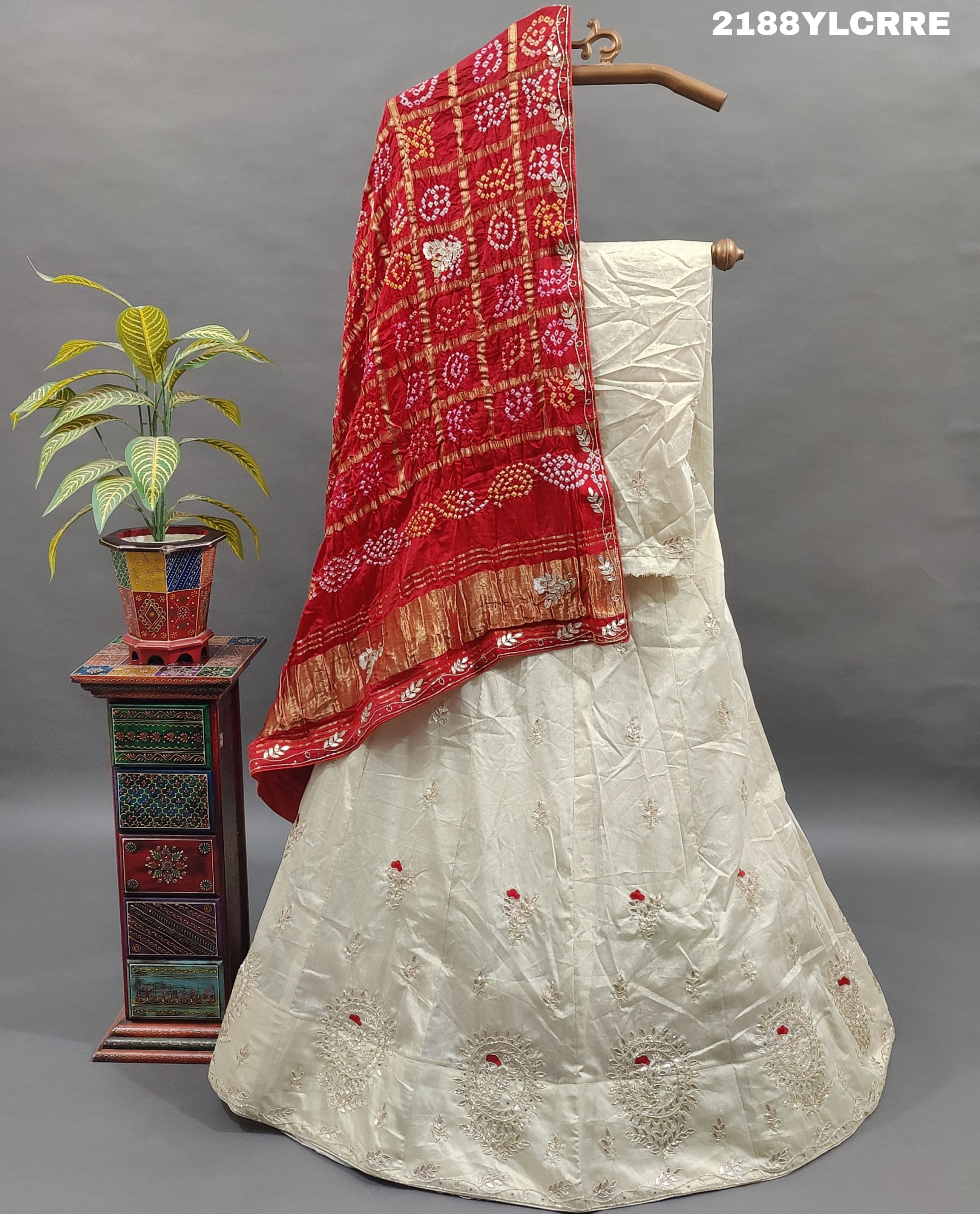 A traditional Indian lehenga with bandhani style and cutdana gotapatti work