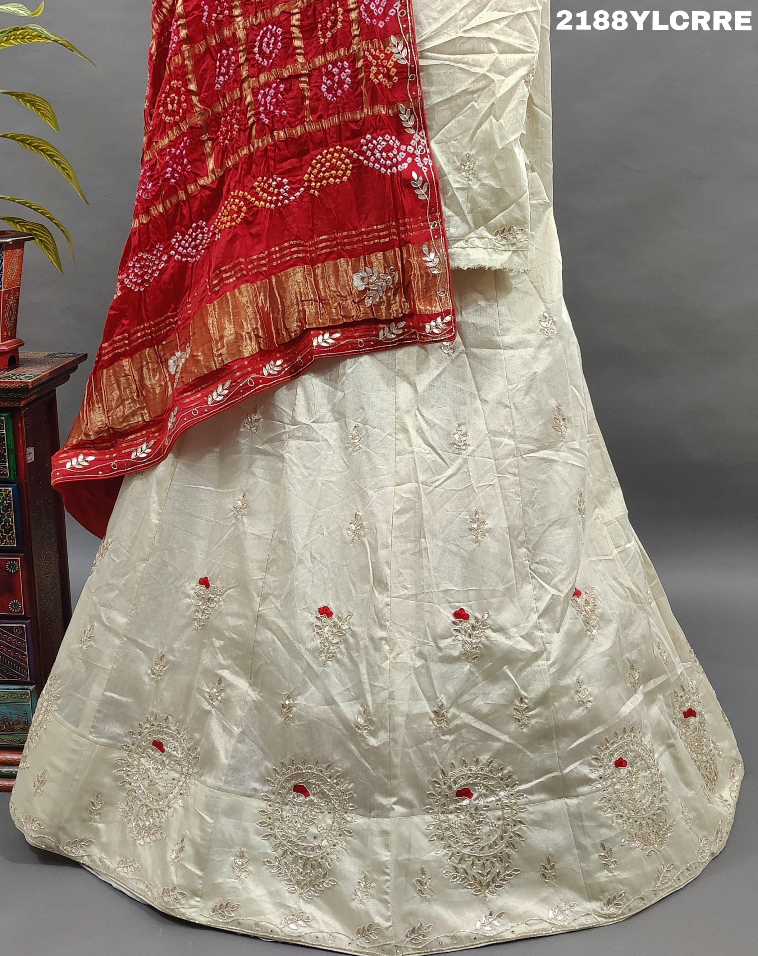 A traditional Indian lehenga with bandhani style and cutdana gotapatti work