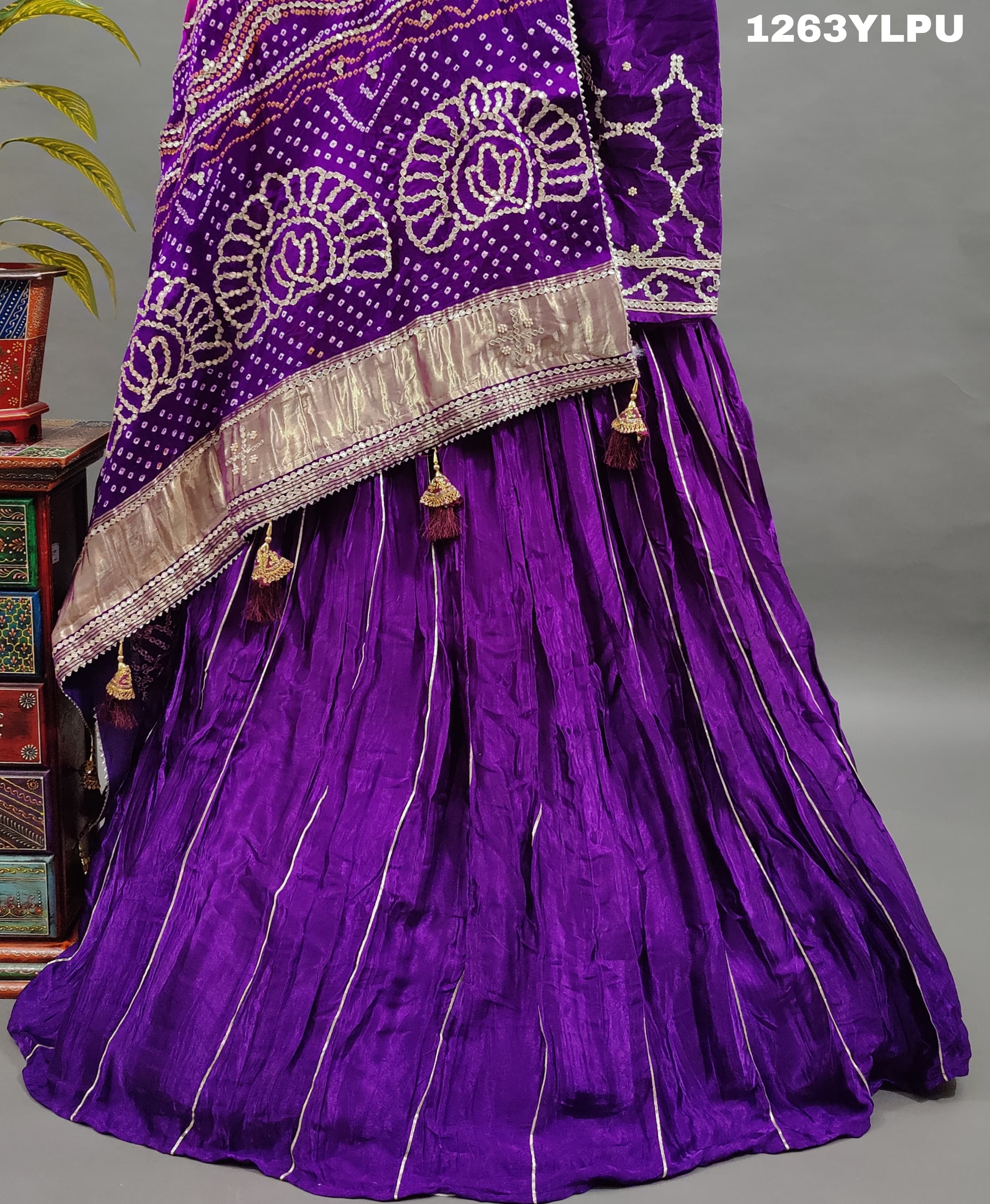 A traditional wear lehenga with bandhani style gotapatti work 
