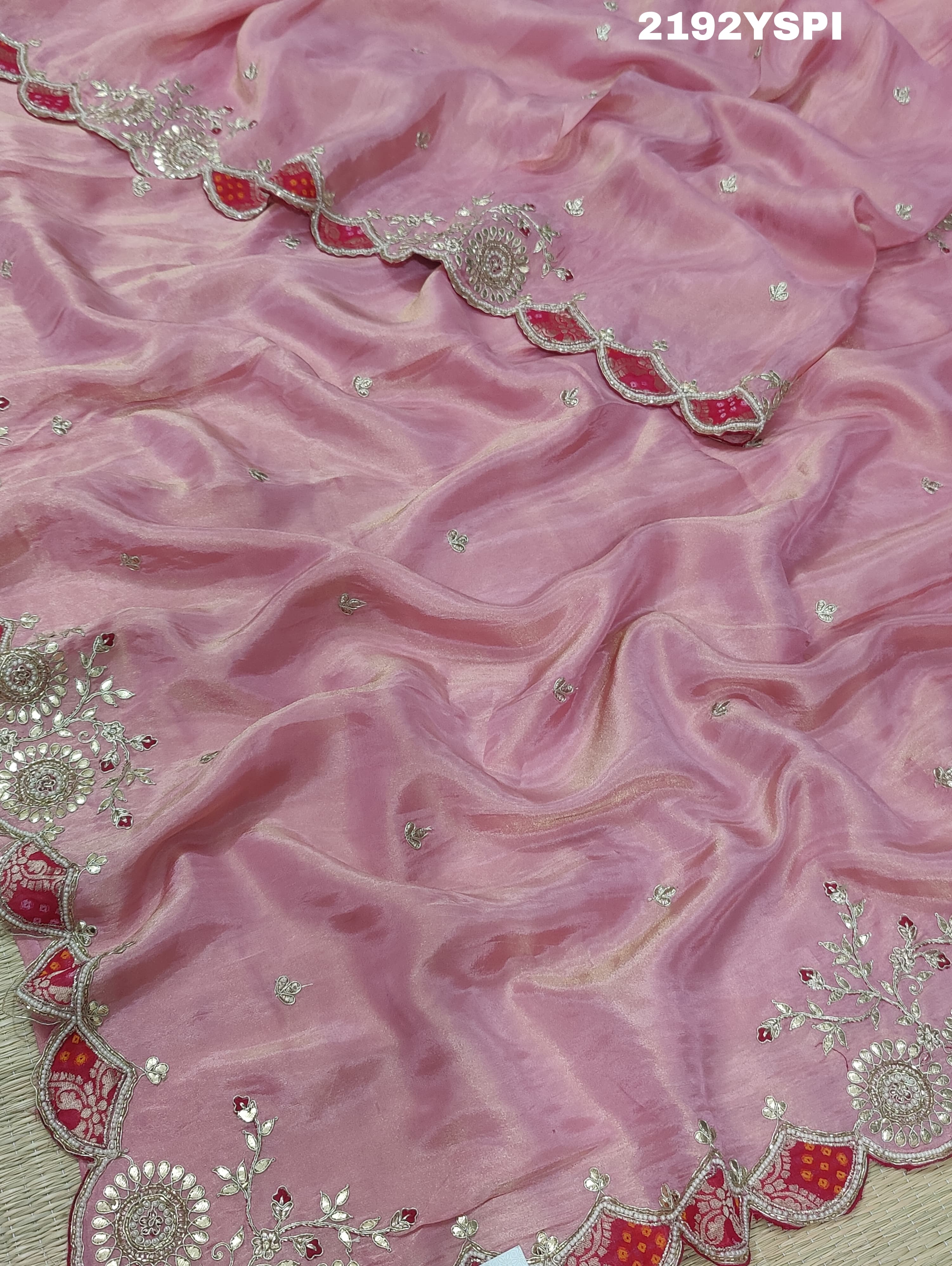 A pink Chinon silk saree with white and silver cutdana bead work and traditional border design.