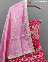 A traditional Indian lehenga choli in pink and white Banarasi silk handwork 