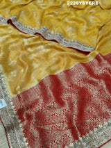 A yellow and red traditional saree with sequence embroidery work and a Banarasi style border.
