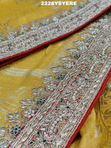 A yellow and red traditional saree with sequence embroidery work and a Banarasi style border.