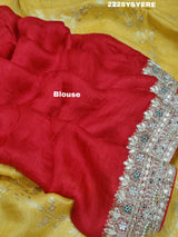 A yellow and red traditional saree with sequence embroidery work and a Banarasi style border.
