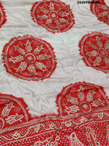 A red and white bandhani style saree with gotapatti work