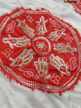 A red and white bandhani style saree with gotapatti work