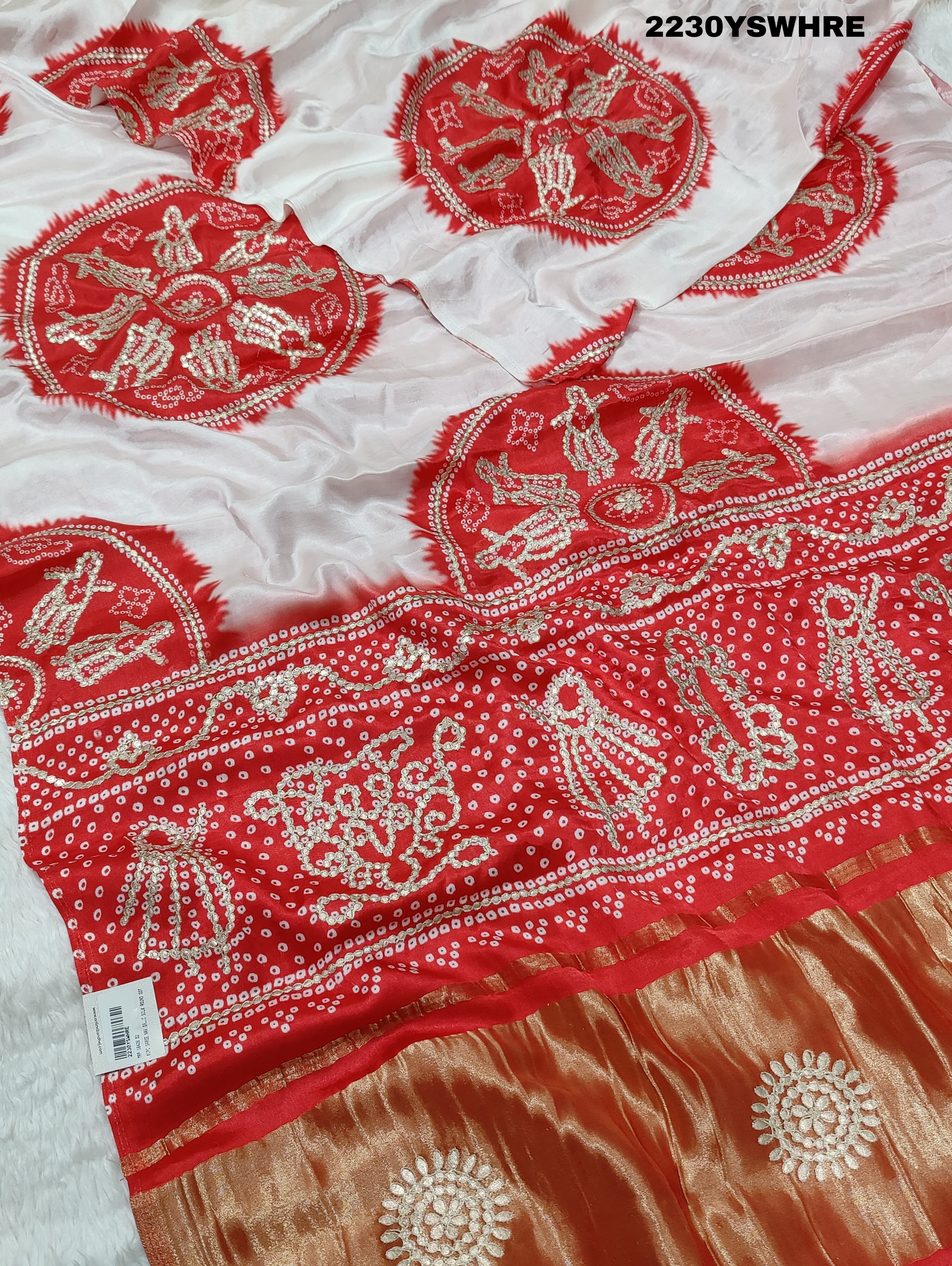 A red and white bandhani style saree with gotapatti work