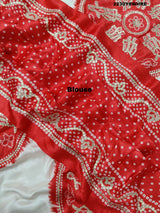 A red and white bandhani style saree with gotapatti work