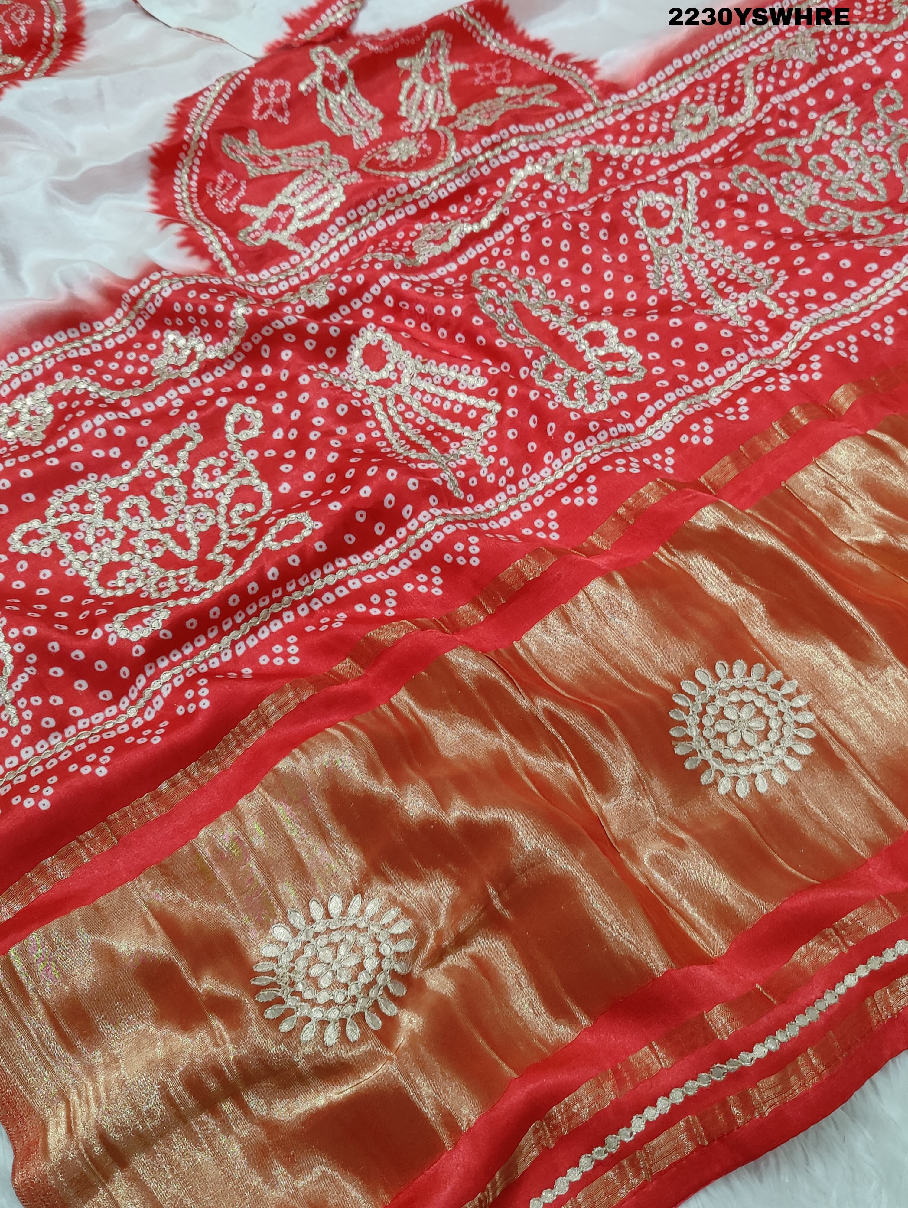 A red and white bandhani style saree with gotapatti work