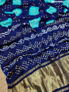 A blue and green bandhani style saree with a floral pattern