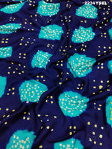 A blue and green bandhani style saree with a floral pattern