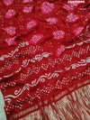 A red and white bandhani style saree 