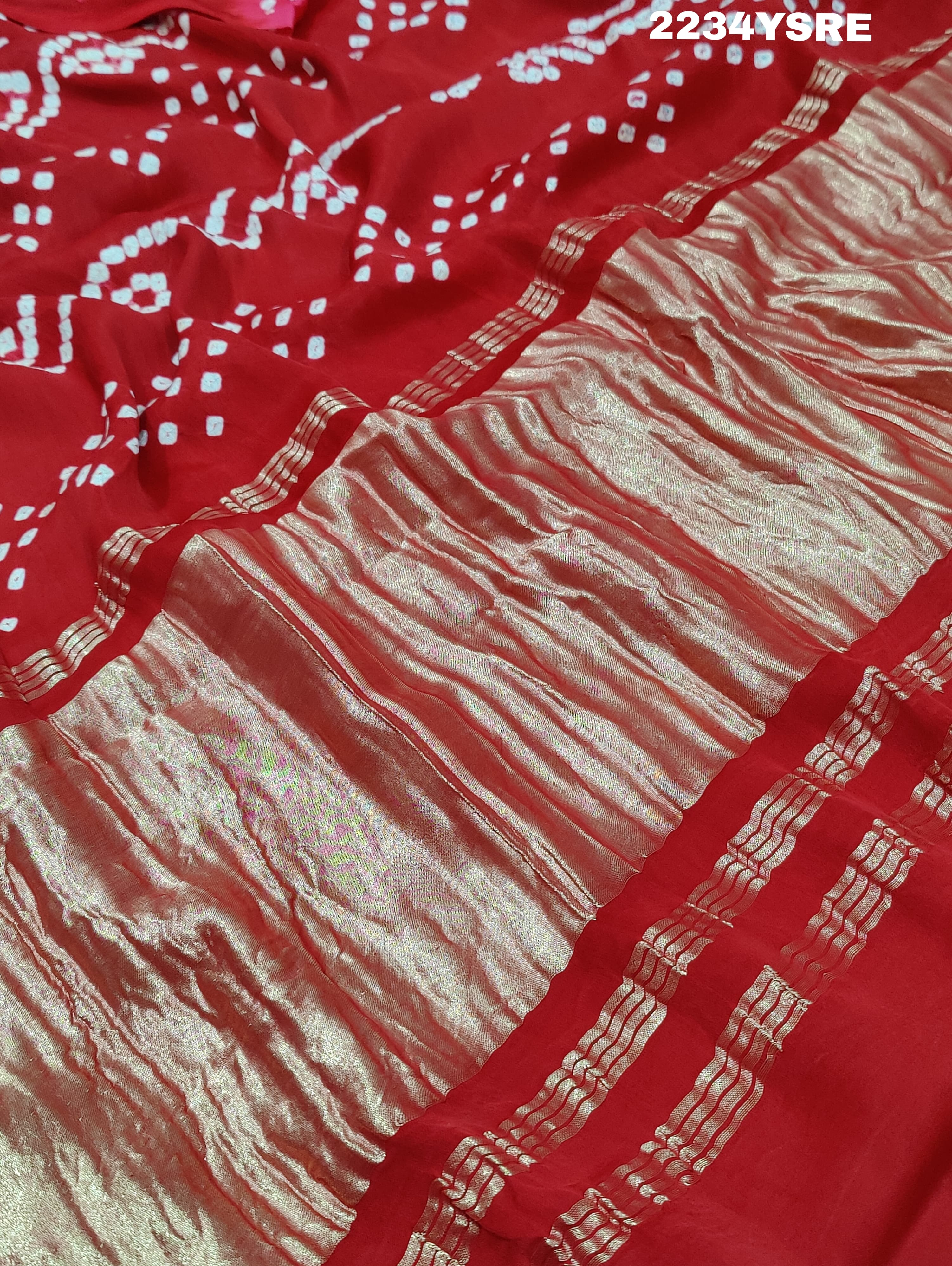 A red and white bandhani style saree 