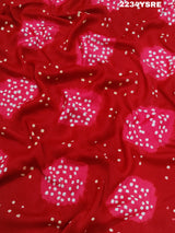 A red and white bandhani style saree 