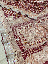 A maroon and gold saree withbandhej patterns and gotapatti handwork.