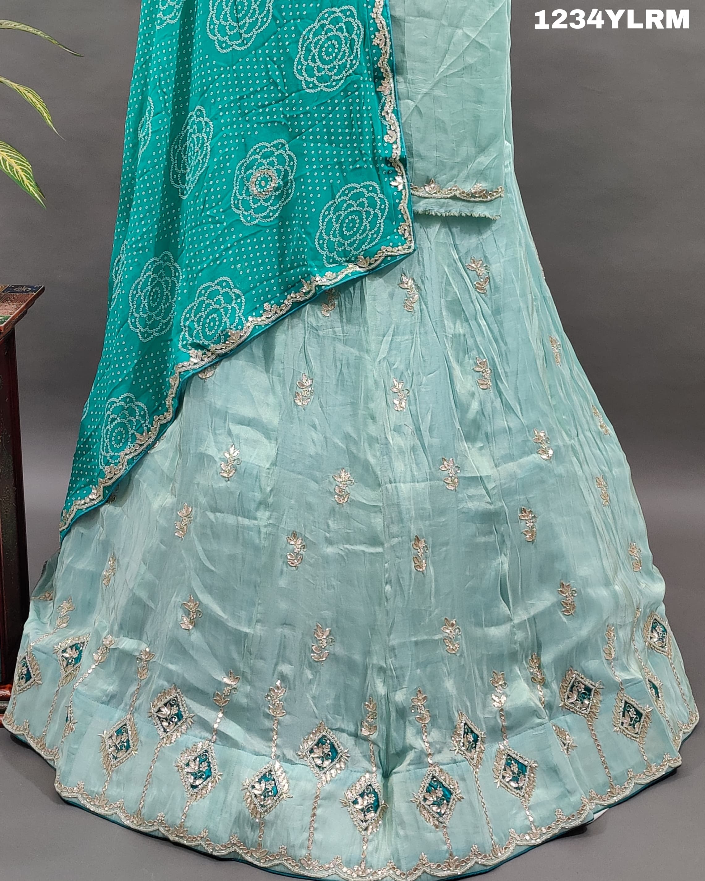 A traditional Indian lehenga with cutdana and gotapatti work
