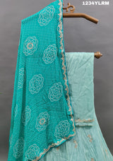A traditional Indian lehenga with cutdana and gotapatti work