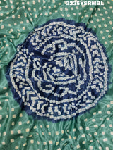 A silk fabric saree with bandhani style patterns in blue and green colors