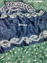 A silk fabric saree with bandhani style patterns in blue and green colors