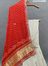 A traditional wear lehenga with bandhani style in red and cream colors 
