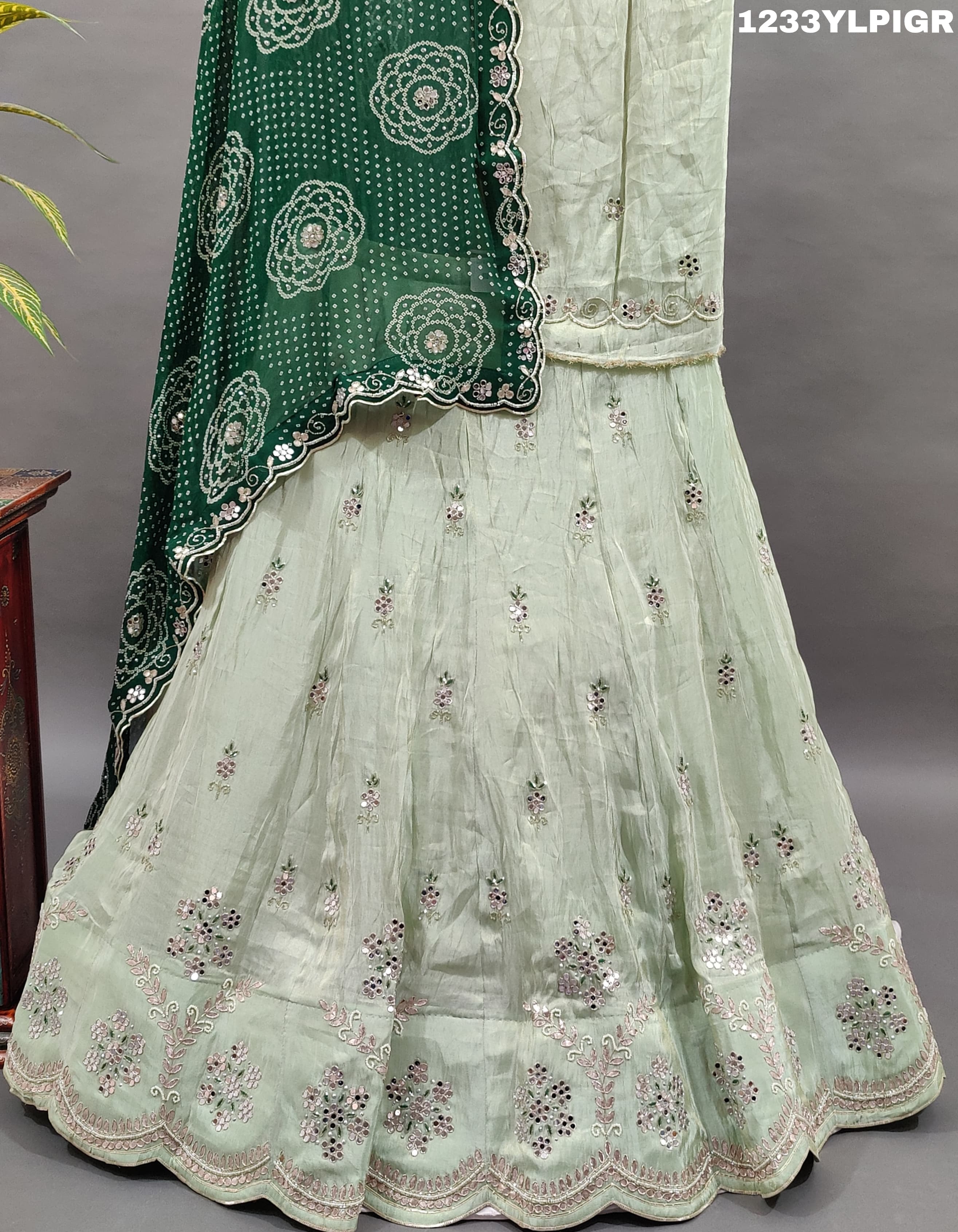 A traditional Indian lehenga set with mirror and gotapatti work