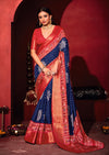 A blue and red bandhani print pashmina silk saree with patola print border