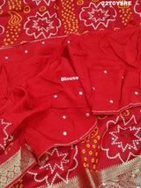 A red and silver bandhani style Dola silk saree with cutdana work and floral patterns, along with a golden border.