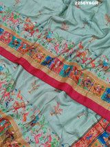 A cotton silk saree with a kalamkari style foil print design featuring multiple colors including red, green, and beige.