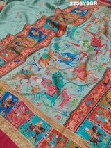 A cotton silk saree with a kalamkari style foil print design featuring multiple colors including red, green, and beige.