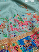 A cotton silk saree with a kalamkari style foil print design featuring multiple colors including red, green, and beige.