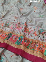 A cotton silk saree with a kalamkari style foil print design in multiple colors including cream, red, and green.