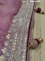 A purple Banarasi silk saree with Bollywood-style embellishments including sequins and gotapatti work, 