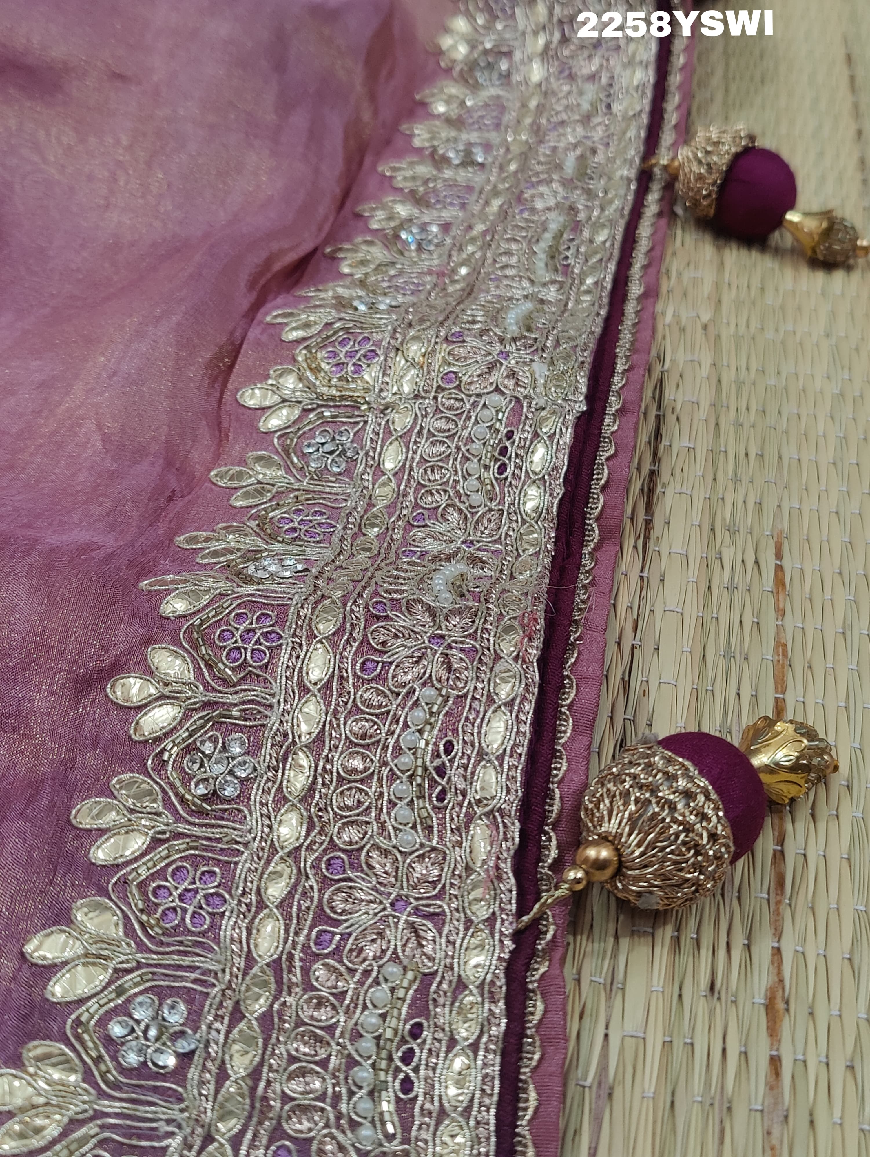 A purple Banarasi silk saree with Bollywood-style embellishments including sequins and gotapatti work, 