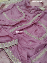 A purple Banarasi silk saree with Bollywood-style embellishments including sequins and gotapatti work, 
