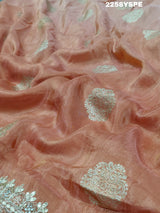 A peach-colored Banarasi silk saree with Bollywood-style embellishments including sequins and gotapatti work, 