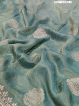 A sea green Banarasi silk saree with Bollywood style embellishments including sequins and gotapatti work
