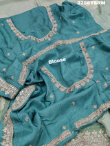 A sea green Banarasi silk saree with Bollywood style embellishments including sequins and gotapatti work