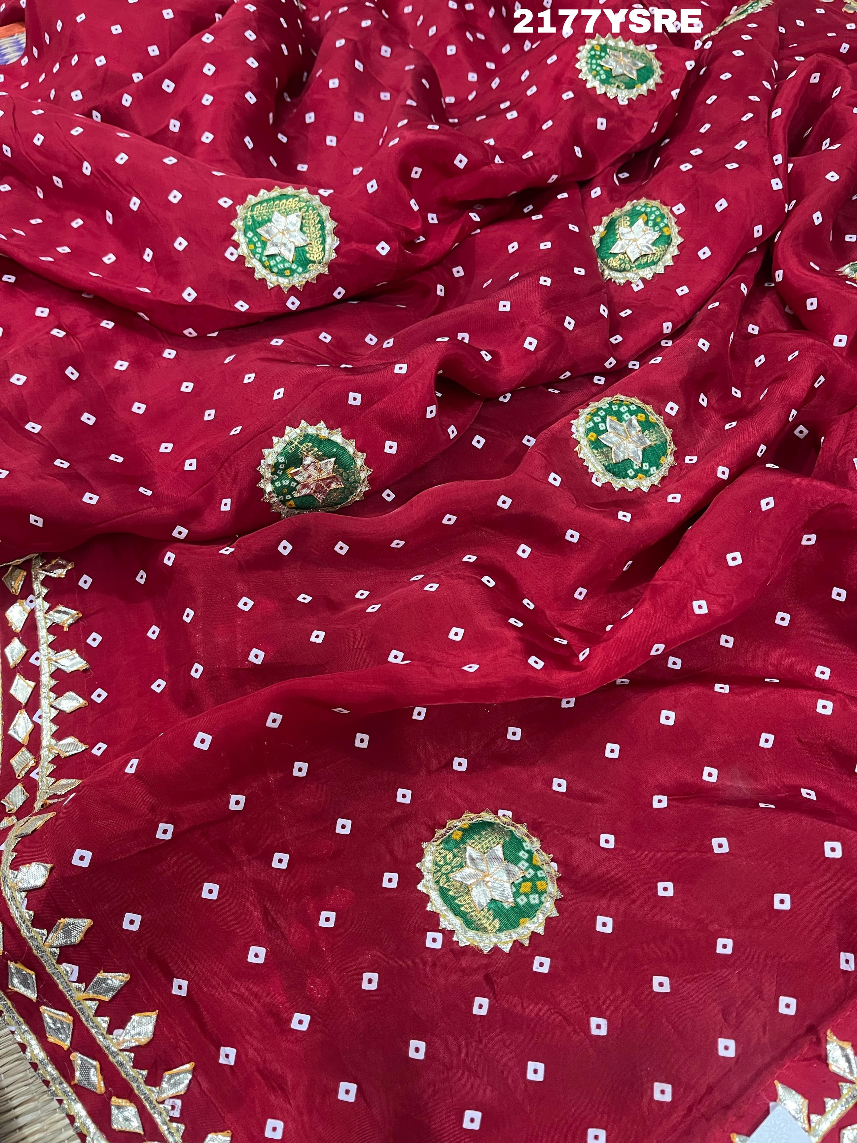 A red and blue modal silk bandhani saree with kachha gotapatti work, including intricate patterns and designs.