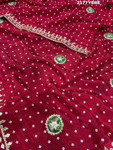 A red and blue modal silk bandhani saree with kachha gotapatti work, including intricate patterns and designs.